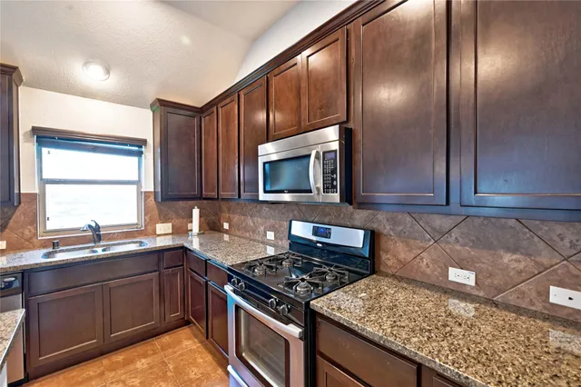 a view of a hallway with wooden floor windows and a living room