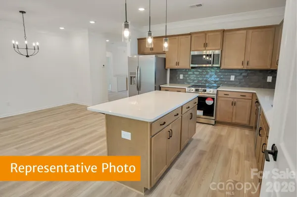 a kitchen with kitchen island cabinets a sink and a stove