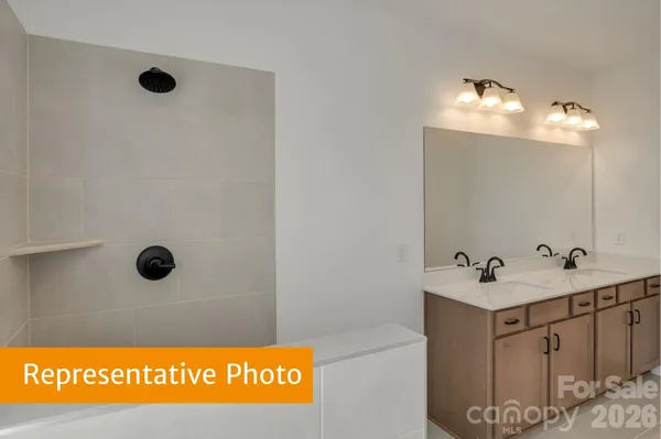 a bathroom with a sink mirror and vanity