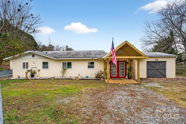 a view of a house with yard and a tree