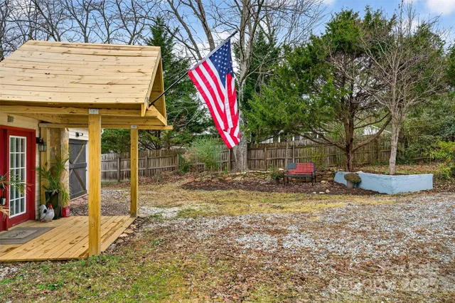 a view of a park with a bench and plants