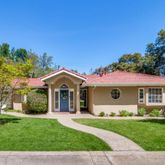 a view of a garden with a house