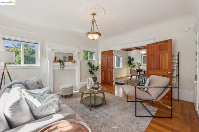 a living room with furniture a dining table and a window