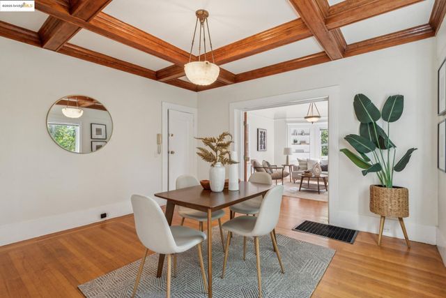 a view of a dining room with furniture and a chandelier