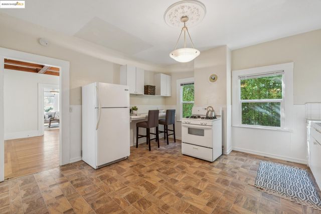 a kitchen with a refrigerator a stove and a sink