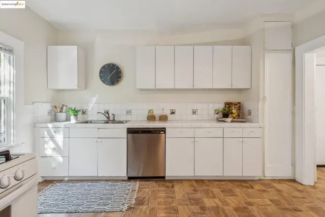 a kitchen with stainless steel appliances granite countertop a sink and a stove