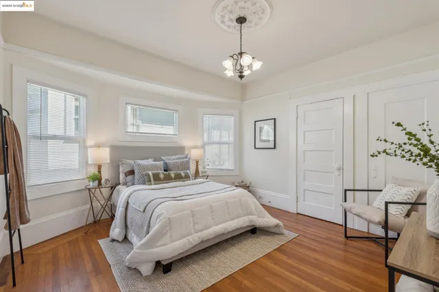 a bedroom with a bed and a chandelier