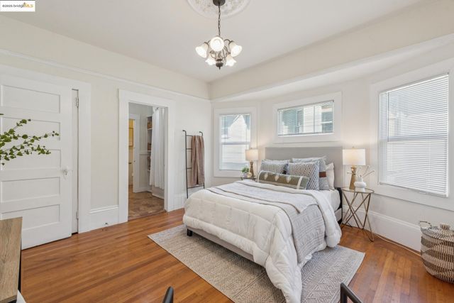 a bedroom with a large bed and chandelier