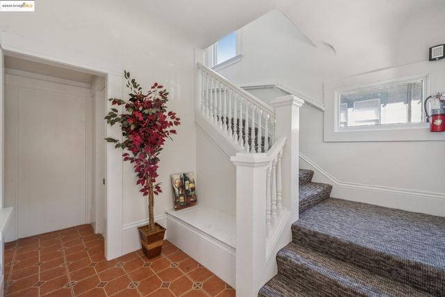 a view of entryway with wooden floor and stairs