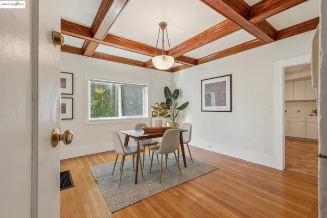 a dining room with furniture a chandelier and wooden floor