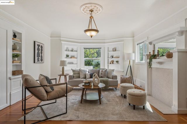 a living room with furniture a window and a chandelier
