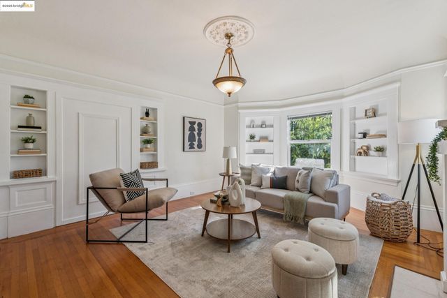a living room with furniture a window and a table