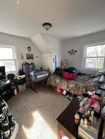 a bedroom with furniture and a window