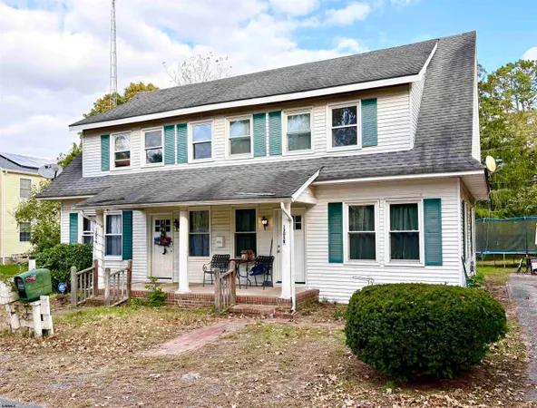 a front view of a house with a garden and porch