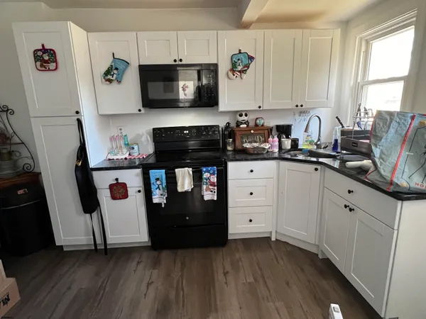 a kitchen with stainless steel appliances a stove microwave and cabinets