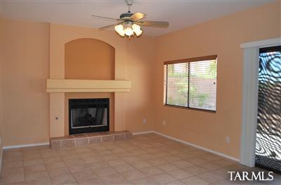 1118 South Riparian Avenue Tucson, AZ 85748 - Photo 10 of 13 a view of a livingroom with a fireplace a ceiling fan and windows
