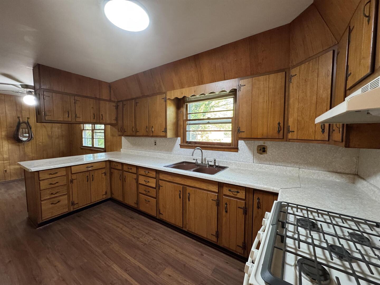 3536 West Grange Hall Road Murphysboro, IL 62966 - Photo 12 of 40 a kitchen with stainless steel appliances wooden floors wooden cabinets a sink and a window