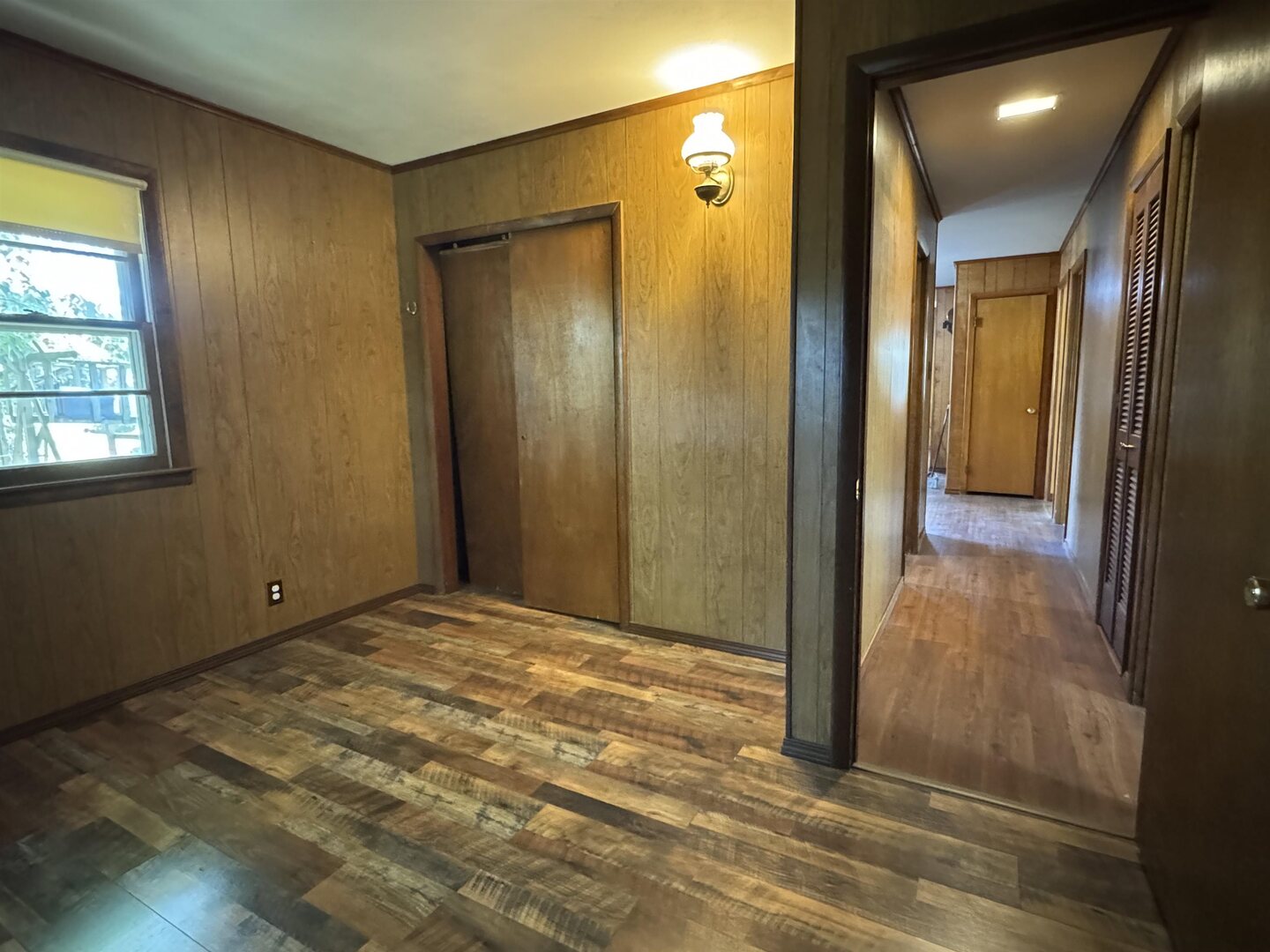 3536 West Grange Hall Road Murphysboro, IL 62966 - Photo 21 of 40 a view of an empty room with wooden floor and a mirror