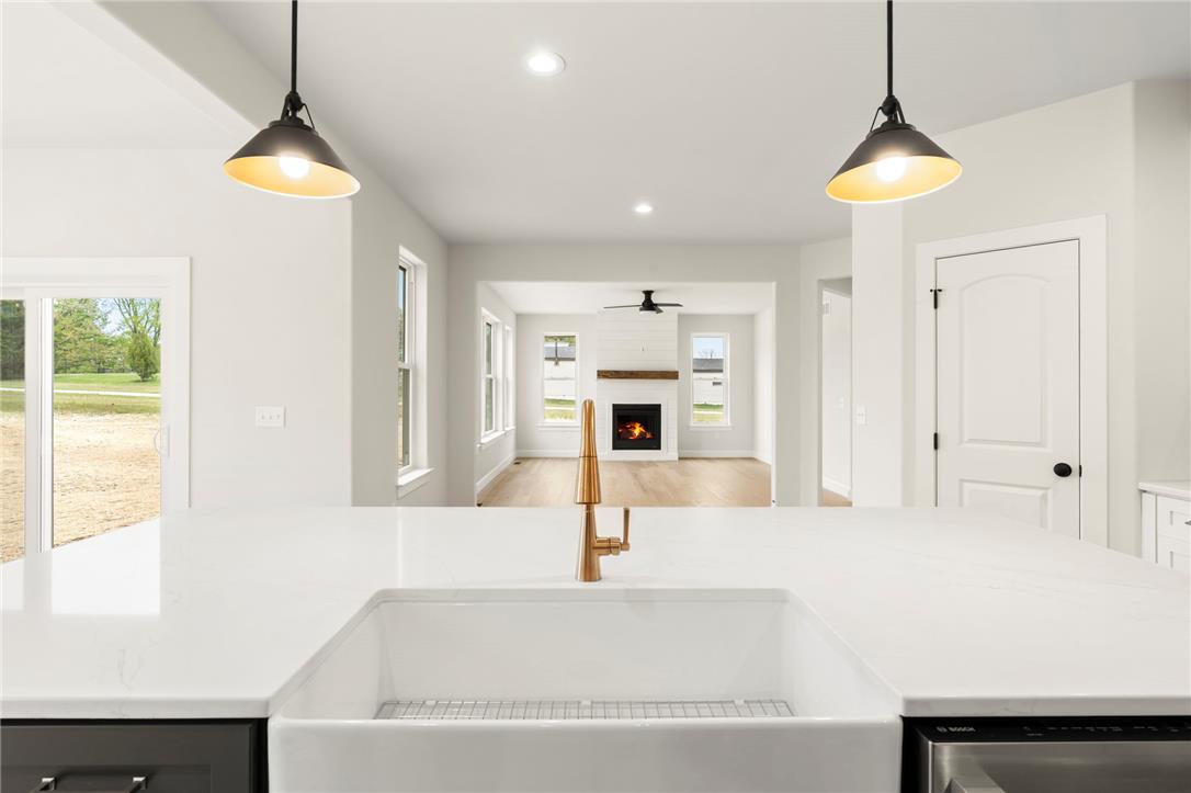 Hottle Road Quakertown, PA 18951 - Photo 19 of 59 An open sightline connects the modern kitchen island directly to the fireplace-anchored living room.