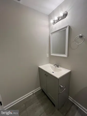 a bathroom with a sink mirror and vanity