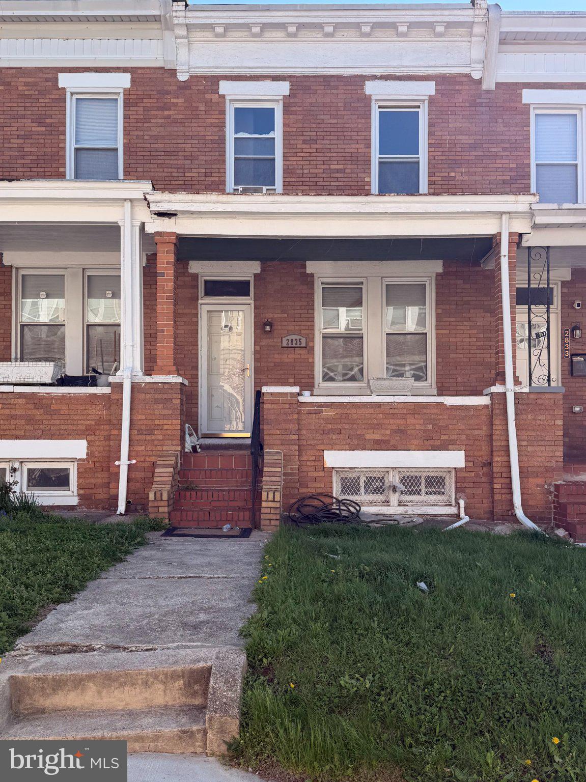 2835 Brendan Avenue Baltimore, MD 21213 - Photo 1 of 1 front view of a brick house with a yard