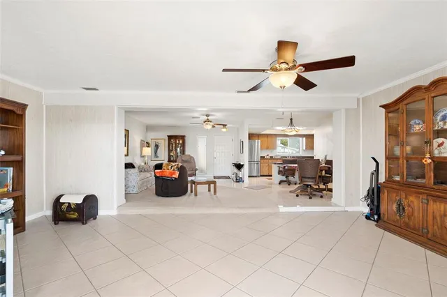 a view of a livingroom with furniture and a ceiling fan