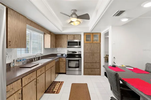 a kitchen with a sink appliances and cabinets