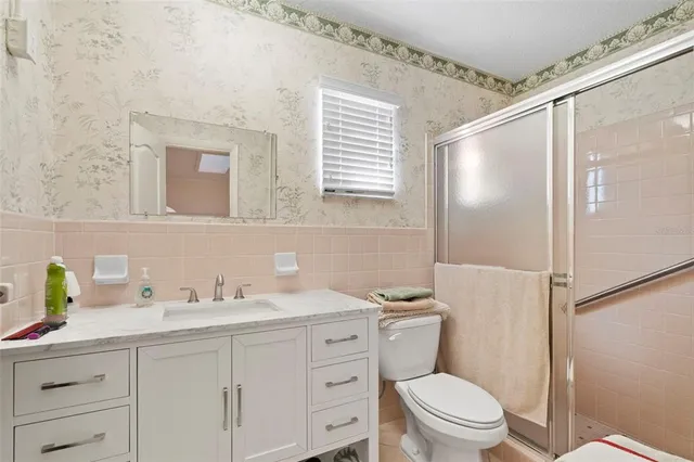 a bathroom with a granite countertop toilet sink and a mirror