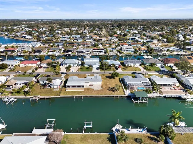 an aerial view of a houses with outdoor space and ocean view