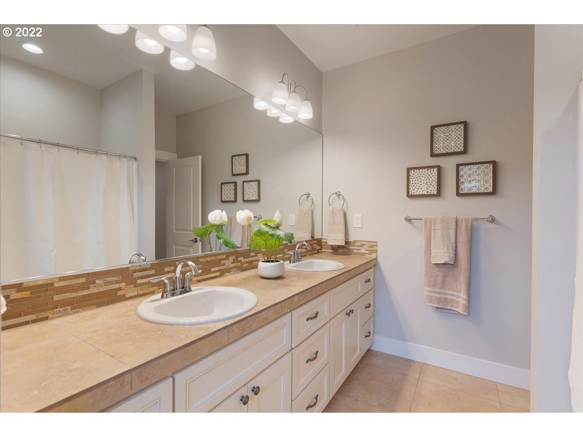 310 Northwest Meridian Ridge Court Portland, OR 97210 - Photo 23 of 32 a bathroom with a sink double vanity granite and a mirror