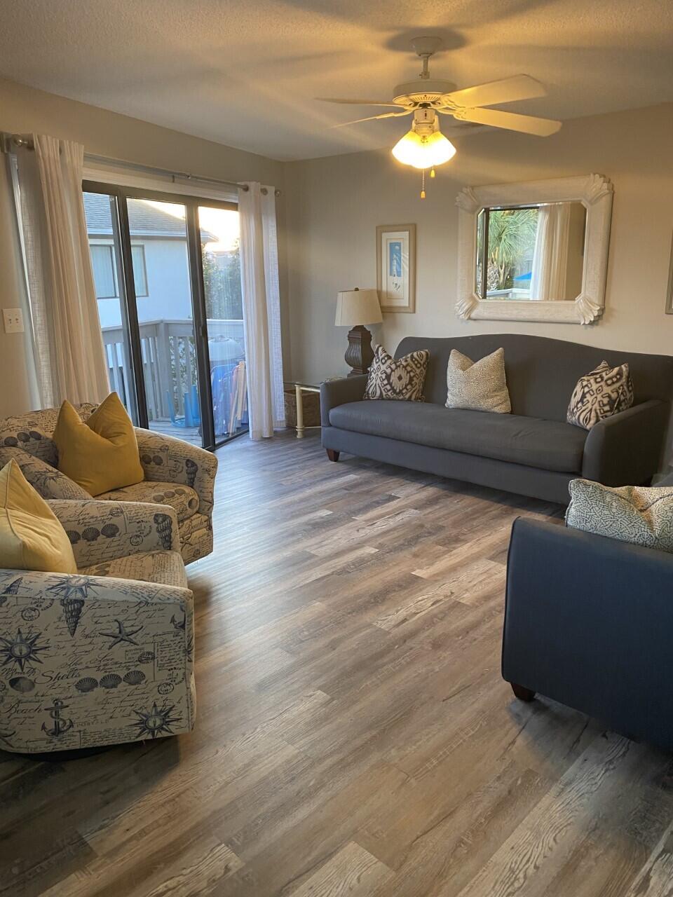 285 Payne Street, Unit 4B Miramar Beach, FL 32550 - Photo 2 of 12 a living room with furniture and a large window