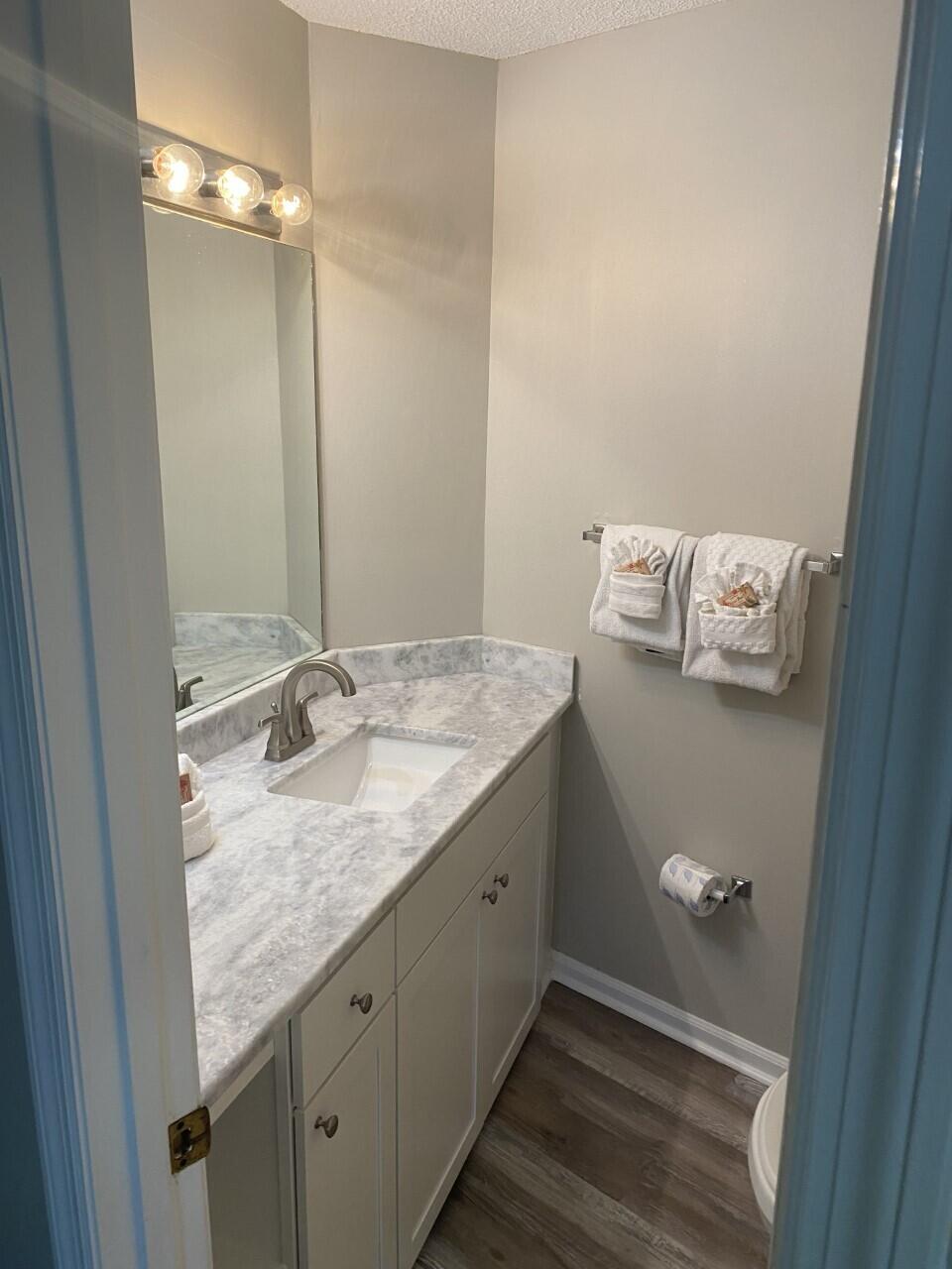 285 Payne Street, Unit 4B Miramar Beach, FL 32550 - Photo 8 of 12 a bathroom with a granite countertop sink and mirror