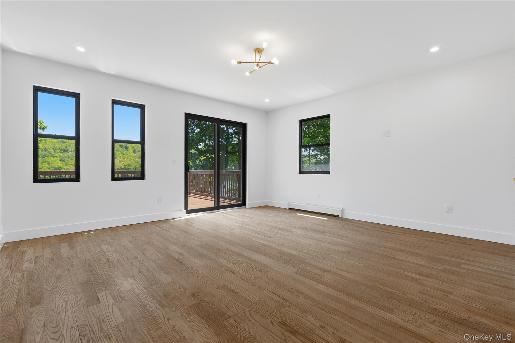 548 Lakes Road Monroe, NY 10950 - Photo 35 of 50 a view of an empty room with a window and wooden floor