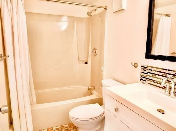 a bathroom with a sink a toilet and a bathtub