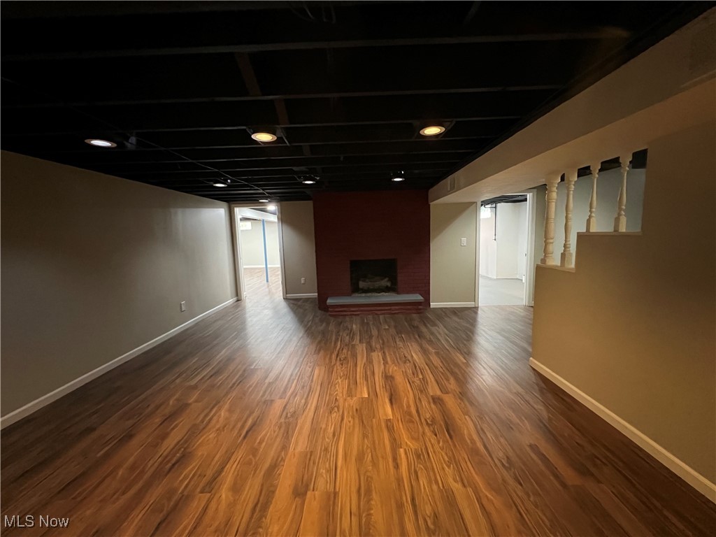 1715 Toepfer Road Akron, OH 44312 - Photo 31 of 49 Basement with wood-type flooring and a brick fireplace