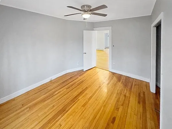 a view of empty room with wooden floor