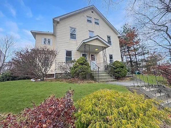 a front view of a house with a garden