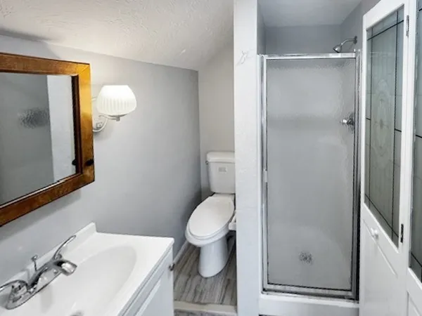 a white toilet sitting next to a bathroom sink