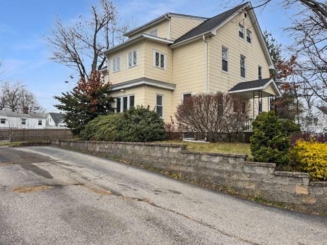 80 Delmont Avenue Worcester, MA 01604 - Photo 4 of 35 a front view of a house with a yard and garage
