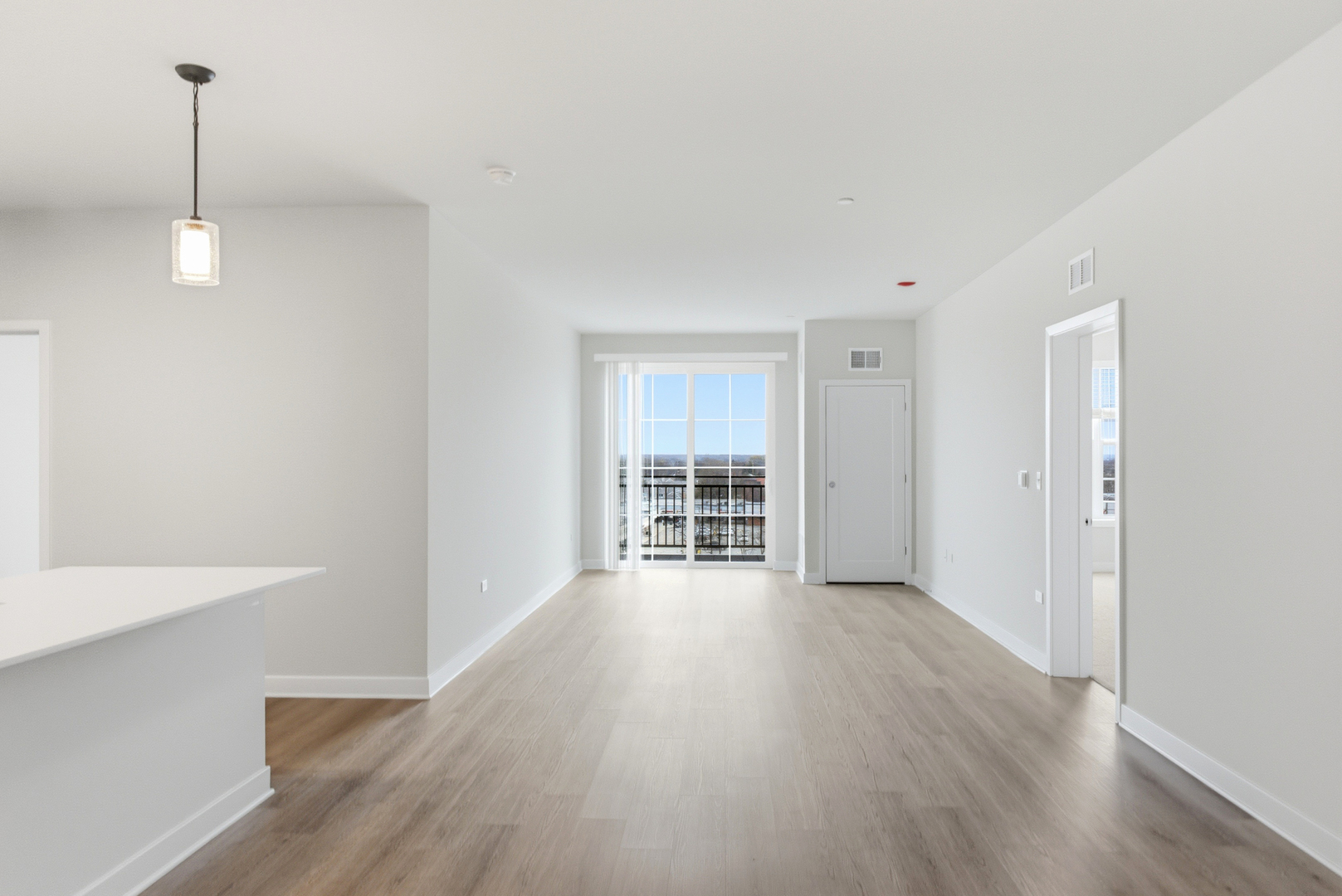 250 McHenry Road, Unit C1 Buffalo Grove, IL 60089 - Photo 32 of 35 a view of an empty room with wooden floor kitchen and a window