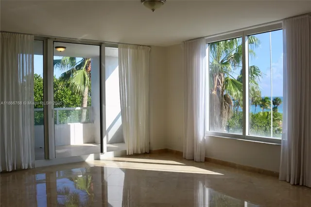 a view of a glass door with a yard from a window