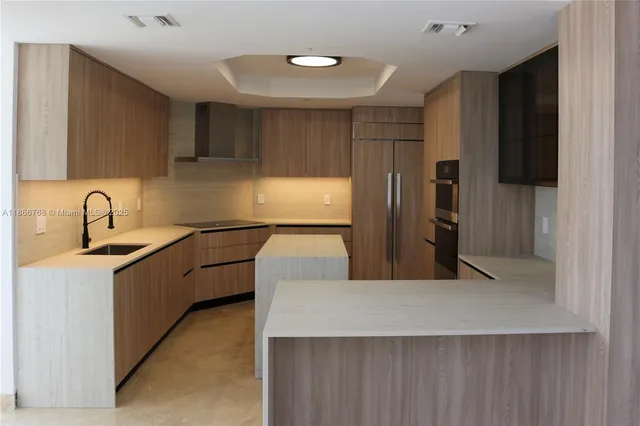 a kitchen with stainless steel appliances a refrigerator sink and microwave