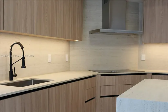a close view of a sink and a dishwasher in a kitchen