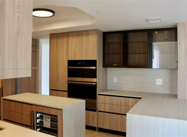 a kitchen with a refrigerator and a stove