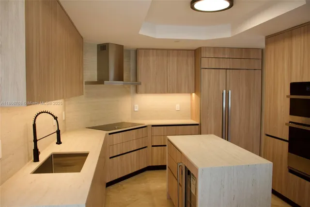 a kitchen with a sink a refrigerator and a stove