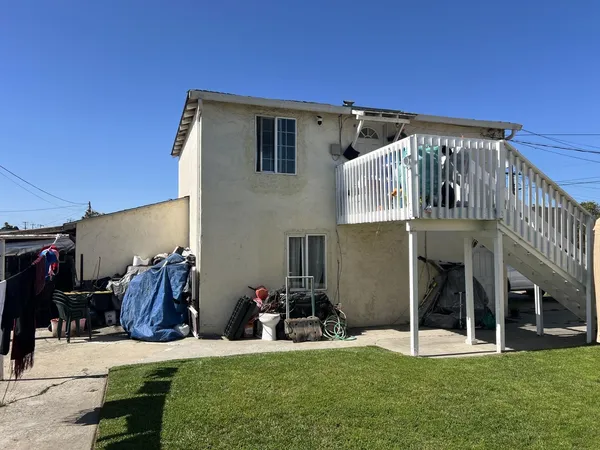a view of a house with many windows and a yard