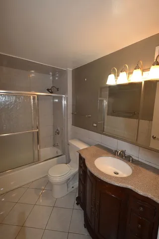 a bathroom with a sink vanity mirror and toilet