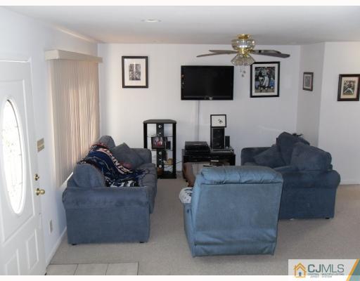 38 Parkerson Road Edison, NJ 08817 - Photo 4 of 8 a living room with furniture and a flat screen tv