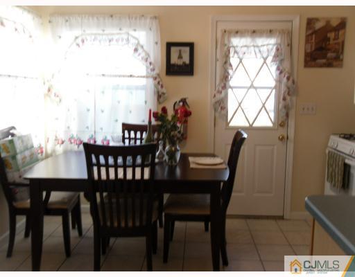 38 Parkerson Road Edison, NJ 08817 - Photo 6 of 8 a view of a dining room with furniture and a window