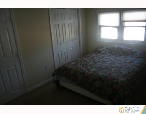 38 Parkerson Road Edison, NJ 08817 - Photo 8 of 8 a bedroom with a bed and a window